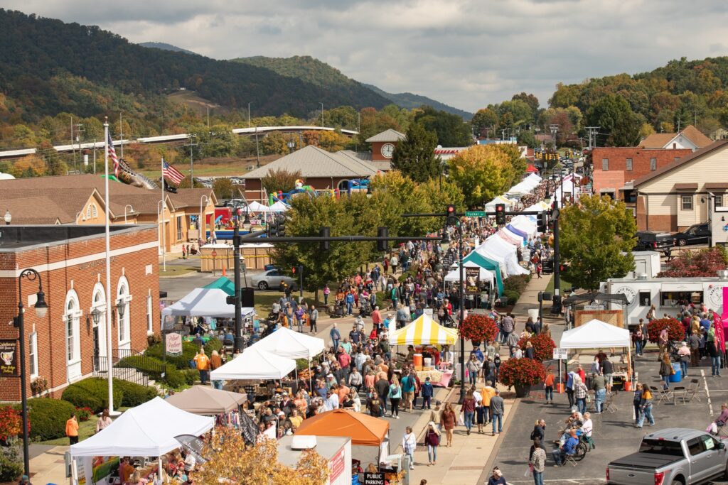 An active street filled with tents and people attending the Unicoi County Apple Festival in Erwin Tennessee