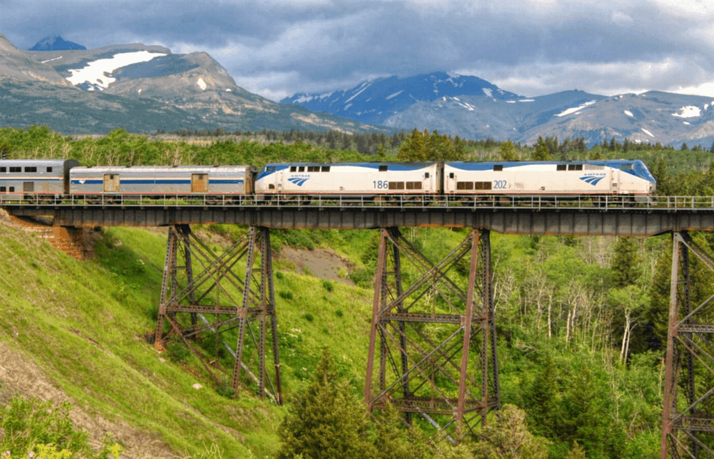 Amtrak Empire Builder Loco Steve Flickr A train crosses a valley between mountains
