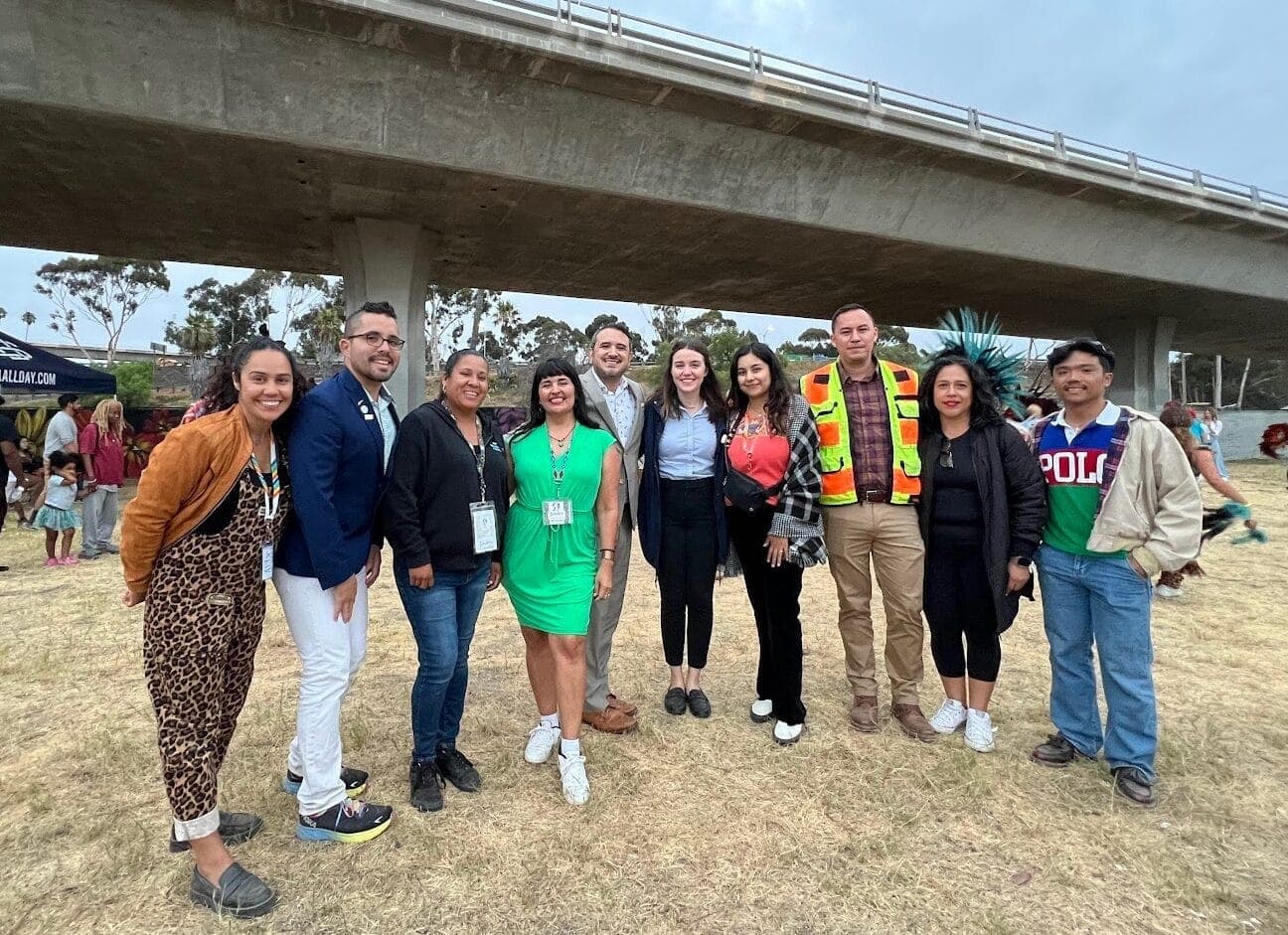 NCSESD Community Connectors Day 1 2024 A group of people smile at the camera from beneath a highway overpass
