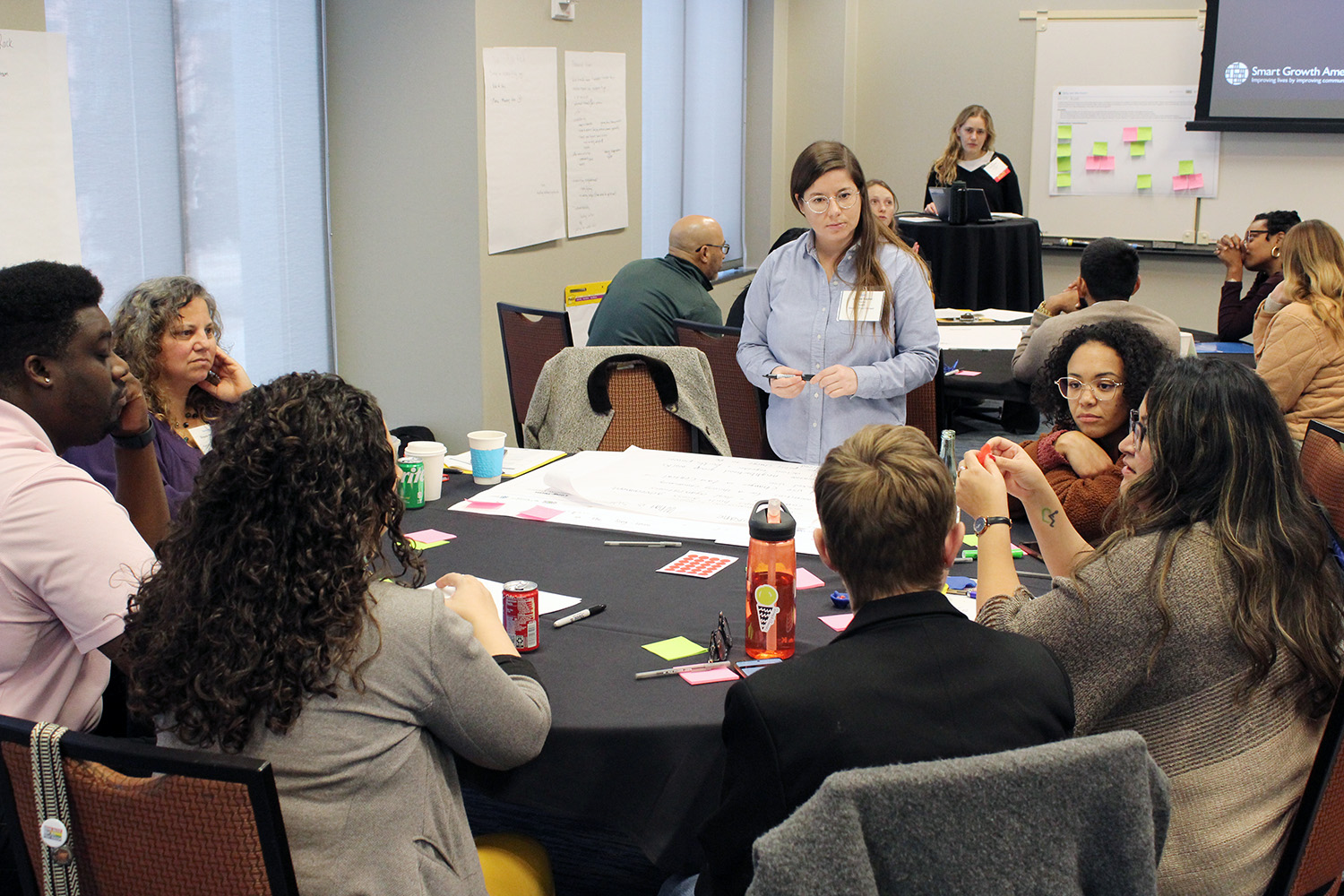 A group of people gather around a table to have a discussion