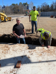 Construction workers get to work converting the vacant lot into a park
