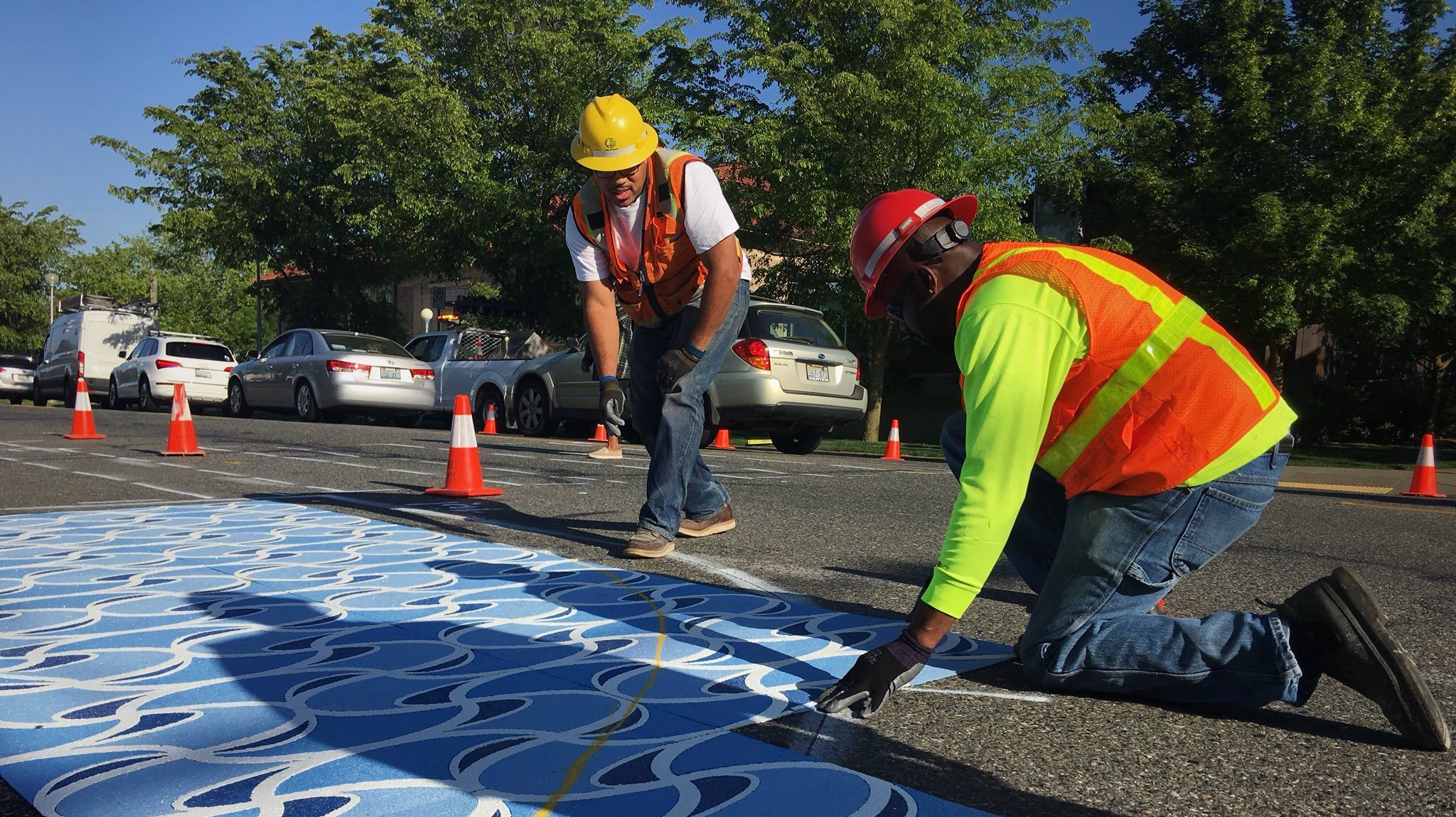 Seattle DOT maintenance staff in orange vests add bulbouts and crosswalks to a neighborhood street